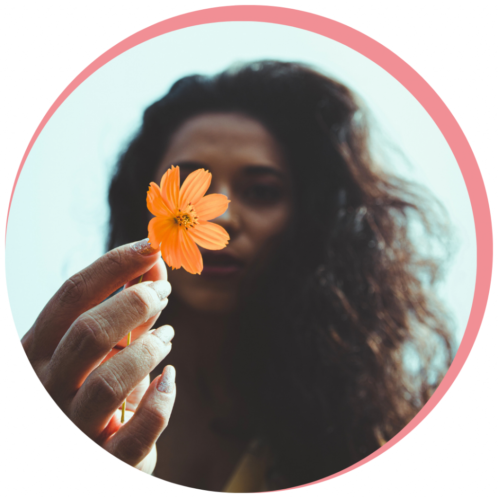 44 1 Home A woman folding a flower to symbolise the beauty of the personalised botox and dermal filler treatment she had at Battersea and Nine Elms Aesthetic Clinic